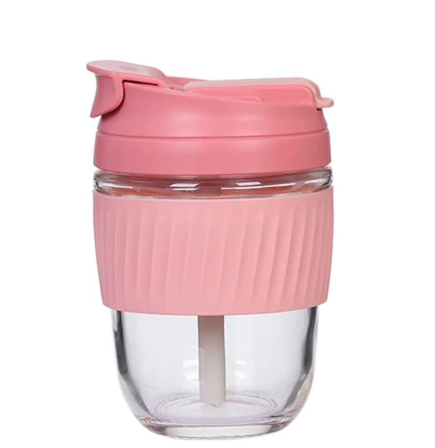 Clear glass tumbler with a pink lid on a white background