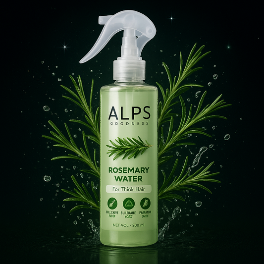 Bottle of Alps Goodness Rosemary Water with green leaves and water droplets on a dark background